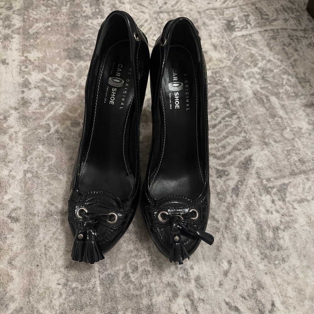 Prada’s The Original Car Shoe Black Tassel Heels in Patent Leather